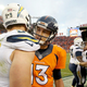 San Diego Chargers defensive end Joey Bosa shares a bro hug with Denver Broncos quarterback Trevor Siemian (Photo: Eric Bakke/Denver Broncos)